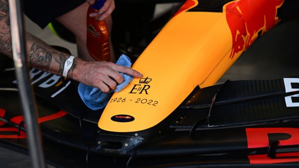 This picture shows a message on the nose of a Red Bull Racing's car to pay tribute after Queen Elizabeth II died at the age of 96, before the third practice session ahead of the Italian Formula One Grand Prix at the Autodromo Nazionale circuit in Monza on September 10, 2022. (Photo by MIGUEL MEDINA / AFP)