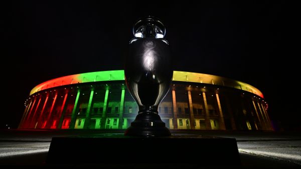 A replica of the UEFA Euro trophy is displayed in front of the Olympic stadium lit up after a presentation of the new UEFA Euro 2024 football championship logo in Berlin, on October 5, 2021. (Photo by John MACDOUGALL / AFP)