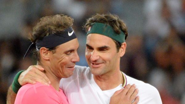 Switzerland's Roger Federer (R) hugs Spain's Rafael Nadal (L) during their tennis match at The Match in Africa at the Cape Town Stadium, in Cape Town on February 7, 2020. / AFP / RODGER BOSCH