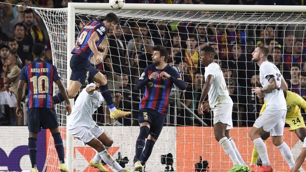 Barcelona's Polish forward Robert Lewandowski scores his team's third goal during the UEFA Champions League 1st round, group C, football match between FC Barcelona and Inter Milan at the Camp Nou stadium in Barcelona on October 12, 2022. (Photo by Josep LAGO / AFP)