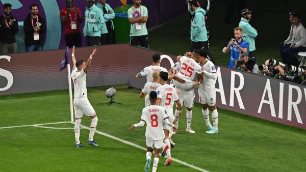 Morocco's midfielder #11 Abdelhamid Sabiri (back) celebrates teammates after he scored his team's first goal during the Qatar 2022 World Cup Group F football match between Belgium and Morocco at the Al-Thumama Stadium in Doha on November 27, 2022. (Photo by Glyn KIRK / AFP)