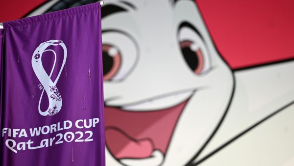 A FIFA banner is displayed in front of a poster of Qatar 2022 mascot La'eeb in Doha on November 7, 2022, ahead of the Qatar 2022 FIFA World Cup football tournament. (Photo by Gabriel BOUYS / AFP)