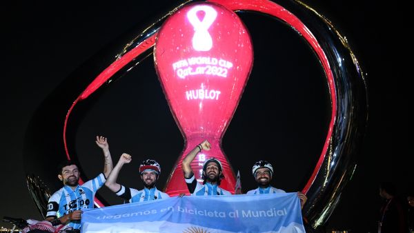 (L-R) Argentina's cyclists Matias Villarroel, Silvio Gatti, Leandro Blanco, and Lucas Ledezma pose for photos in front of the FIFA World Cup countdown clock upon arriving in Doha on November 7, 2022, ahead of the Qatar 2022 FIFA World Cup football tournament. (Photo by Kirill KUDRYAVTSEV / AFP)