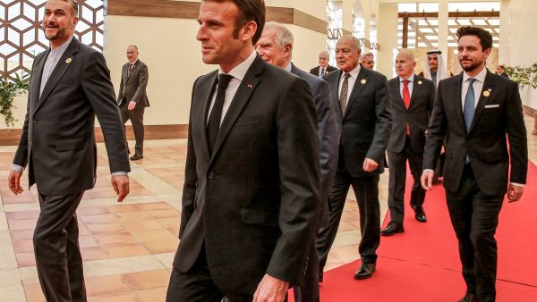Macron flanked by....