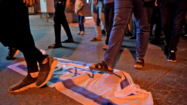 Stepping on the Israeli flag 