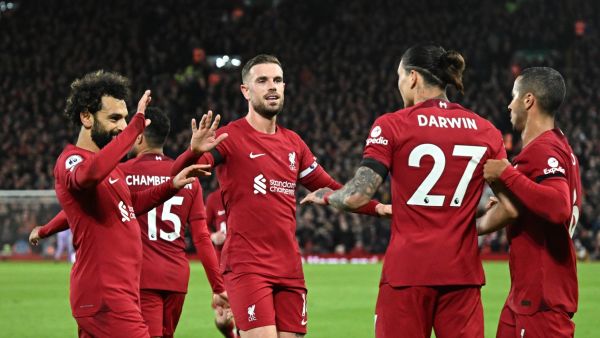 Liverpool's teammates celebrate the second owngoal scored by Leicester City's Belgian defender Wout Faes during the English Premier League football match between Liverpool and Leicester City at Anfield in Liverpool, north west England on December 30, 2022. (Photo by Oli SCARFF / AFP)
