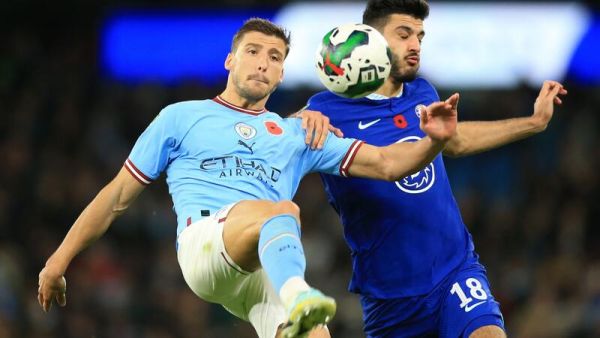 Manchester City's Portuguese defender Ruben Dias (L) vies with Chelsea's Albanian forward Armando Broja (R) during the English League Cup third round football match between Manchester City and Chelsea at the Etihad stadium in Manchester, northwest England on November 9, 2021. (Photo by Lindsey Parnaby / AFP) 