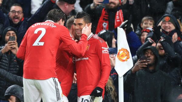 Manchester United's Brazilian midfielder Casemiro (R) celebrates scoring the opening goal with Manchester United's Swedish defender Victor Lindelof (L) during the English Premier League football match between Manchester United and Bournemouth at Old Trafford in Manchester, north west England, on January 3, 2023. (Photo by Lindsey Parnaby / AFP) 