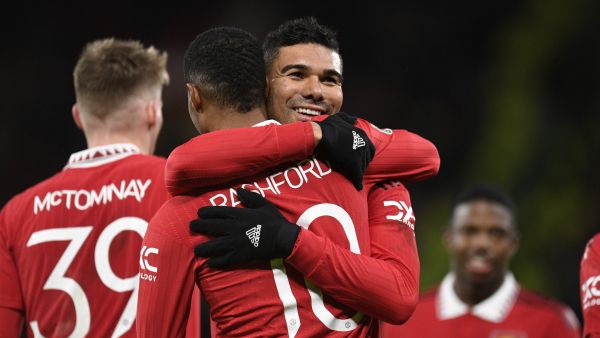 Manchester United's English striker Marcus Rashford celebrates with Manchester United's Brazilian midfielder Casemiro after scoring their third goal during the English League Cup quarter final football match between Manchester United and Charlton Athletic, at Old Trafford, in Manchester, north-west England on January 10, 2023. - Man Utd won the game 3-0. (Photo by Oli SCARFF / AFP)
