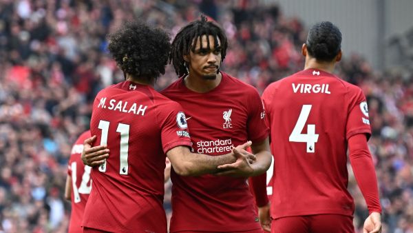 Liverpool's Egyptian striker Mohamed Salah (L) celebrates with Liverpool's English defender Trent Alexander-Arnold (C) after scoring their third goal during the English Premier League football match between Liverpool and Nottingham Forest at Anfield in Liverpool, north west England on April 22, 2023. (Photo by Paul ELLIS / AFP)