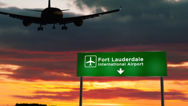 Airplane flying over sign for Fort Lauderdale-Hollywood International Airport