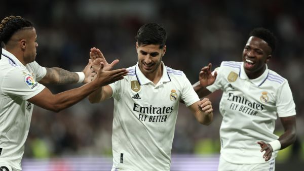 Real Madrid's Spanish midfielder Marco Asensio celebrates with Real Madrid's Brazilian forward Vinicius Junior (R) and Real Madrid's Dominican forward Mariano Diaz (L) scoring his team's first goal during the Spanish league football match between Real Madrid CF and Getafe CF at the Santiago Bernabeu stadium in Madrid on May 13, 2023. (Photo by Thomas COEX / AFP)