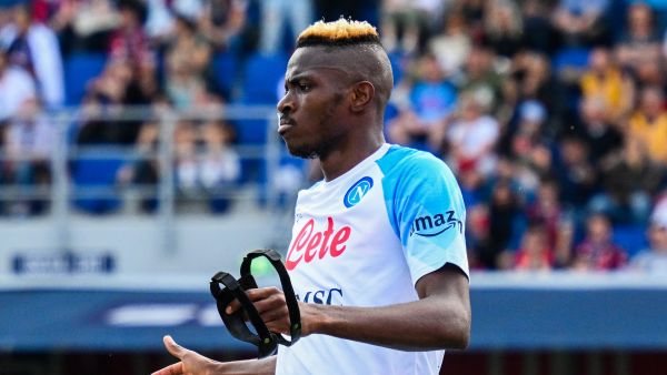 Napoli's Nigerian forward Victor Osimhen takes off his face mask as he celebrates after scoring his side's second goal during the Italian Serie A football match between Bologna and Napoli on May 28, 2023 at the Renato-Dall'Ara stadium in Bologna. (Photo by Vincenzo PINTO / AFP)