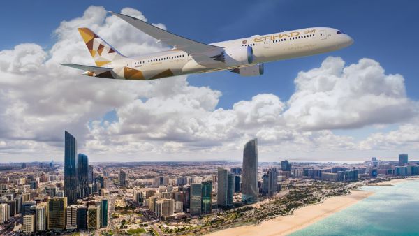 An Etihad Dreamliner flying over Abu Dhabi Etihad Airways Among Most Punctual Airlines In Middle East For H1 2023