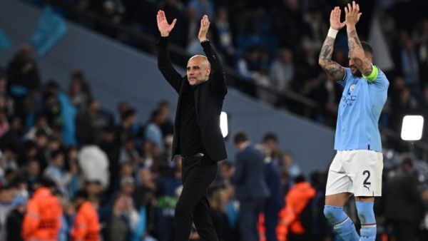 Manchester City's Spanish manager Pep Guardiola (L) and Manchester City's English defender Kyle Walker applauds the fans following the UEFA Champions League second leg semi-final football match between Manchester City and Real Madrid at the Etihad Stadium in Manchester, north west England, on May 17, 2023. Manchester City won the match 4-0. (Photo by Paul ELLIS / AFP)