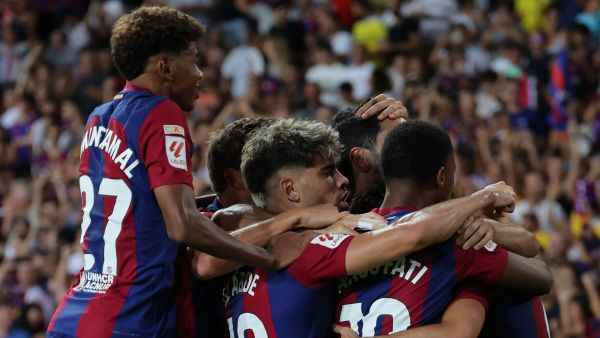 Barcelona's players celebrate their team's first goal during the Spanish Liga football match between FC Barcelona and Cadiz CF at the Lluis Companys Olimpic Stadium in Barcelona on August 20, 2023. (Photo by LLUIS GENE / AFP)