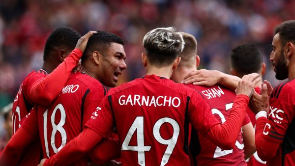 Manchester United's Brazilian midfielder Casemiro (L) celebrates scoring his team third goal during the pre-season friendly football match between Manchester United and Lens at Old Trafford stadium, in Manchester, on August 5, 2023. (Photo by Darren Staples / AFP)