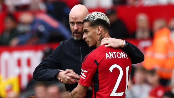 Manchester United's Brazilian midfielder Antony (R) is congratulated by Manchester United's Dutch manager Erik ten Hag (L) as he leaves the pitch during the pre-season friendly football match between Manchester United and Lens at Old Trafford stadium, in Manchester, on August 5, 2023. (Photo by Darren Staples / AFP)