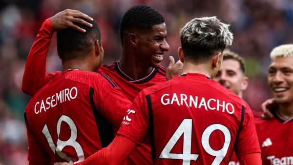 Manchester United's Brazilian midfielder Casemiro (L) celebrates scoring his team third goal during the pre-season friendly football match between Manchester United and Lens at Old Trafford stadium, in Manchester, on August 5, 2023. (Photo by Darren Staples / AFP)