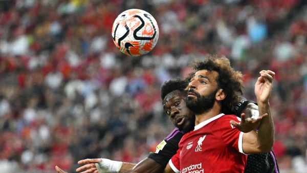 Liverpool's Egyptian striker Mohamed Salah (front) fights for the ball against Bayern Munich's Canadian midfielder Alphonso Davies during the Singapore Festival of Football pre-season friendly match in Singapore on August 2, 2023. (Photo by MOHD RASFAN / AFP)
