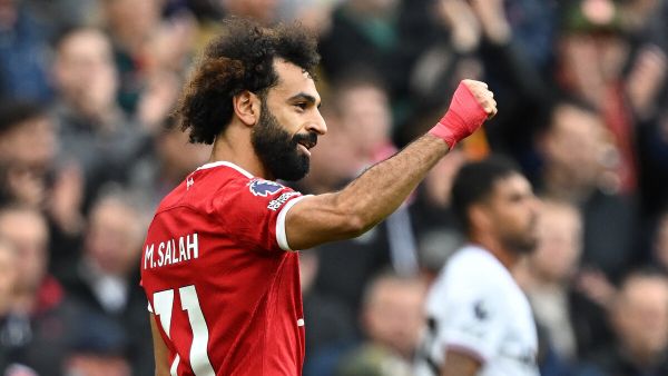 Liverpool's Egyptian striker #11 Mohamed Salah celebrates after scoring the opening goal from the penalty spot during the English Premier League football match between Liverpool and West Ham United at Anfield in Liverpool, north west England on September 24, 2023. (Photo by Paul ELLIS / AFP)