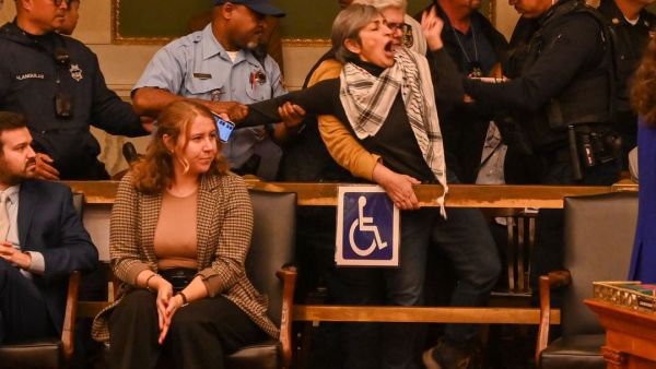 Susan Abulhawa being violently escorted out of Philadelphia City hall. (Joe Piette)
