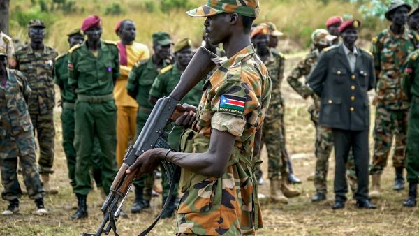 A South Sudanese soldier monitors the area as troops belonging to the South Sudanese Unified Forces take part in a deployment ceremony. (Louis Gume/AFP)
