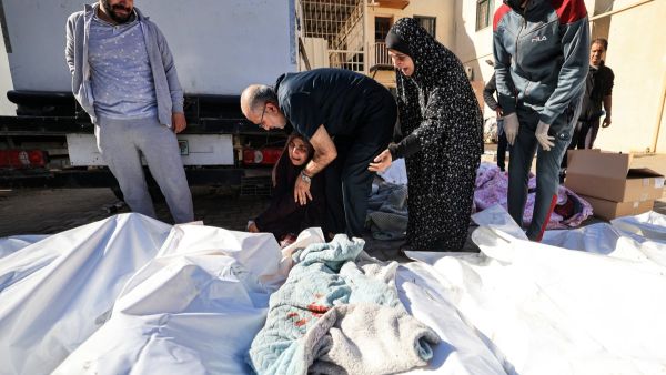 A woman mourns during the funeral of Al Hajj family at the Al-Aqsa Hospital in Deir el-Balah, in the central Gaza Strip on November 21, 2023. (Mahmud Hams/ AFP)