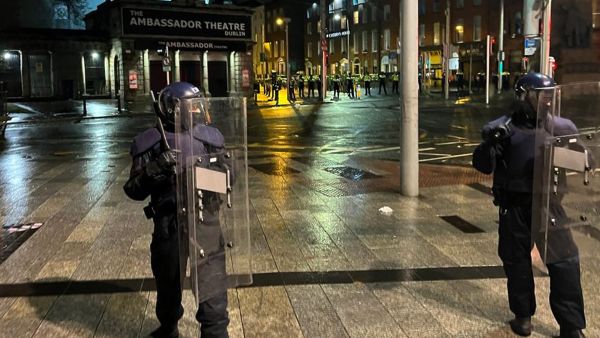 Irish Garda riot police form a cordon at the junction of Parnell Street and O'Connell Street Upper, after a police car was set on fire in Dublin. (Peter Murphy/ AFP)