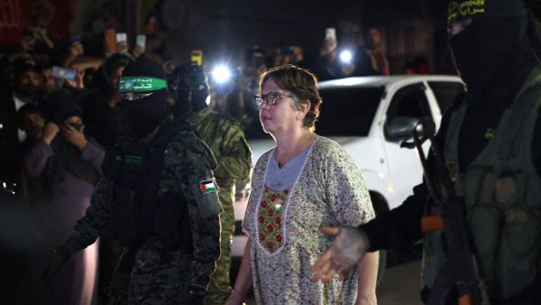 Hamas fighters accompanying a newly released Israeli hostage. (AFP)