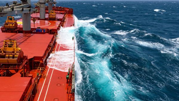 Cargo ship rolling in stormy sea