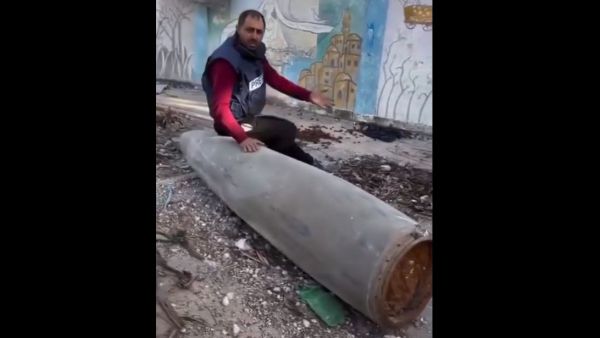 صحفي فلسطيني يجلس على صاروخ لم ينفجر