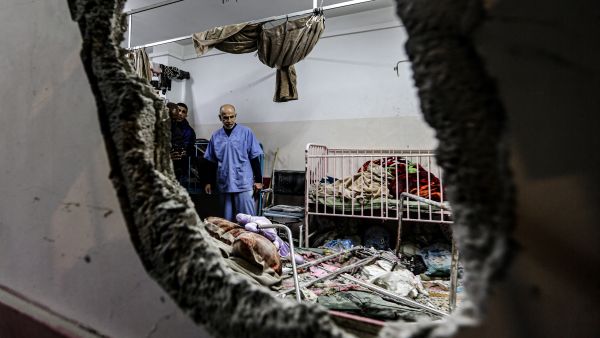 People inspect the damage in a room following Israeli bombardment at Nasser hospital in Khan Yunis in the southern Gaza Strip. (Stringer/ AFP)
