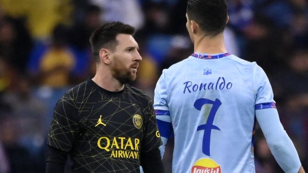 Paris Saint-Germain's Argentine forward Lionel Messi (L) walks past Riyadh All-Star's Portuguese forward Cristiano Ronaldo (R) during the Riyadh Season Cup football match between the Riyadh All-Stars and Paris Saint-Germain at the King Fahd Stadium in Riyadh on January 19, 2023. (Photo by FRANCK FIFE / AFP)