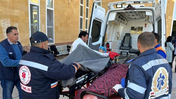 Egyptian paramedics transport an injured Palestinian child to a Red Crescent ambulance upon his arrival from Gaza via the Rafah border crossing, on January 10, 2024 amid the ongoing conflict between Israel and the militant group Hamas. (Photo by AFP)