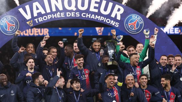 Paris Saint-Germain' players celebrate with the trophy after winning the French Champions' Trophy (Trophee des Champions) football match between Paris Saint-Germain (PSG) and Toulouse FC at the Parc des Princes stadium in Paris on January 3, 2024. (Photo by FRANCK FIFE / AFP)
