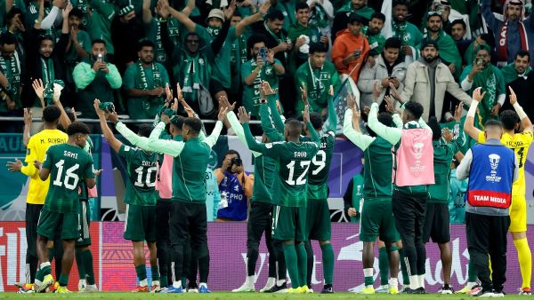 Saudi Arabia's players celebrate with their supporters after the Qatar 2023 AFC Asian Cup Group F football match between Kyrgyzstan and Saudi Arabia at the Ahmad Bin Ali Stadium in Al-Rayyan, west of Doha on January 21, 2024. (Photo by KARIM JAAFAR / AFP)