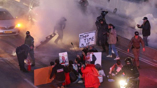 Israeli security forces disperse supporters and families of hostages held in Gaza since the October 7 attacks after they blocked the Ayalon highway in Tel Aviv calling for their release on February 10, 2024