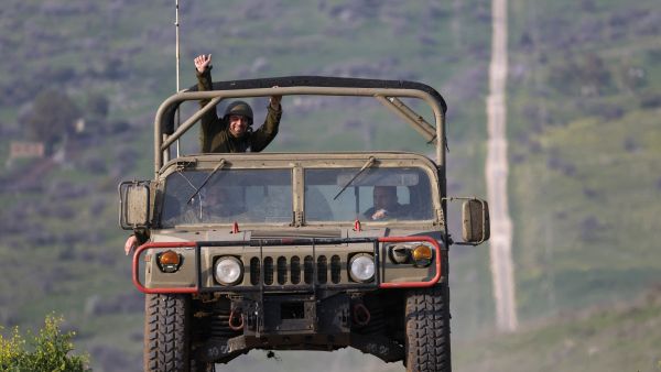An Israeli military vehicle makes its way through the Israeli-annexed Golan Heights near the border with Lebanon, on February 27, 2024,
