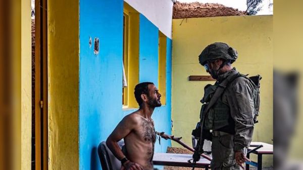 Photo of an Israeli soldier torturing a Palestinian man. (X/@ytirawi)