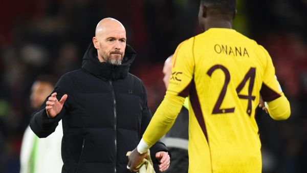 Manchester United's Dutch manager Erik ten Hag shakes hands with Manchester United's Cameroonian goalkeeper #24 Andre Onana after the UEFA Champions League group A football match between Manchester United and FC Bayern Munich at Old Trafford stadium in Manchester, north west England, on December 12, 2023. (Photo by PETER POWELL / AFP)