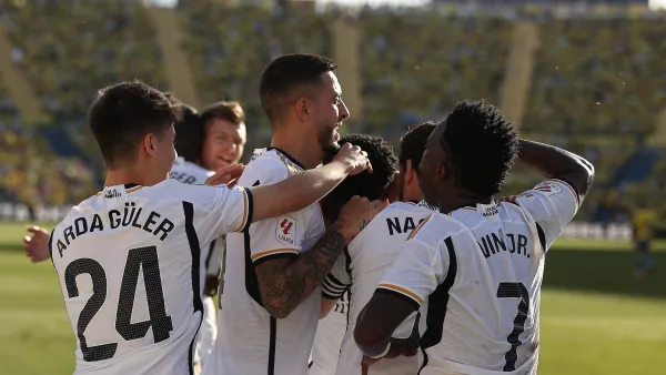 Real Madrid's French defender #18 Aurelien Tchouameni celebrates with teammates after scoring his team's second goal during the Spanish league football match between UD Las Palmas and Real Madrid CF at the Gran Canaria stadium in Las Palmas de Gran Canaria on January 27, 2024. (Photo by DESIREE MARTIN / AFP)