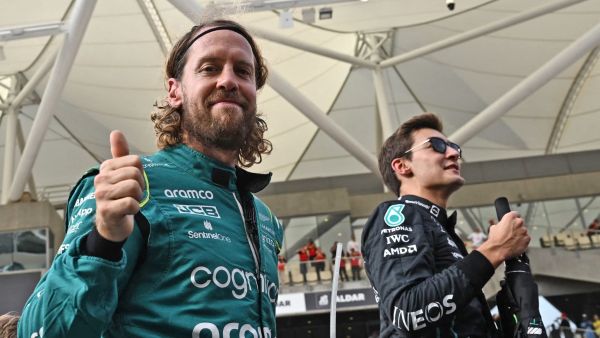 Aston Martin's German driver Sebastian Vettel (L) gives the thumbs-up as he arrives for an end-of-season drivers group picture ahead of the Abu Dhabi Formula One Grand Prix at the Yas Marina Circuit in the Emirati city of Abu Dhabi on November 20, 2022. (Photo by Ben Stansall / AFP)