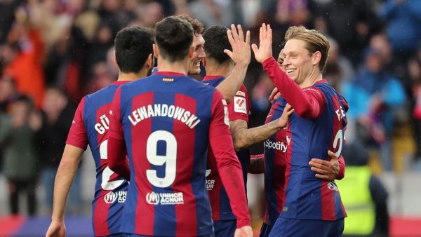 Barcelona's Dutch midfielder #21 Frenkie de Jong (R) celebrates with teammates scoring his team's third goal with teammates during the Spanish league football match between FC Barcelona and Getafe CF at the Estadi Olimpic Lluis Companys in Barcelona on February 24, 2024. (Photo by LLUIS GENE / AFP)