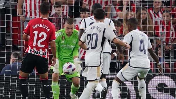 Real Madrid's Ukrainian goalkeeper #13 Andriy Lunin stops the ball during the Spanish Liga football match between Athletic Bilbao and Real Madrid at the San Mames stadium in Bilbao on August 12, 2023. (Photo by CESAR MANSO / AFP)