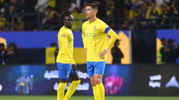 Nassr's Senegalese Forward #10 Sadio Mane and Nassr's Portuguese forward #07 Cristiano Ronaldo react during the Saudi Pro League football match between Al-Nassr and Al-Raed in Riyadh's Al-Awal Park Stadium on March 7, 2024. (Photo by Fayez NURELDINE / AFP)