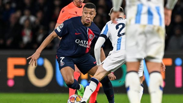 Paris Saint-Germain's French forward #07 Kylian Mbappe (CL) fights for the ball with Real Sociedad's Spanish midfielder #22 Benat Turrientes (CR) during the UEFA Champions League round of 16 first leg football match between Paris Saint-Germain (PSG) and Real Sociedad at the Parc des Princes Stadium in Paris, on February 14, 2024. (Photo by MIGUEL MEDINA / AFP)