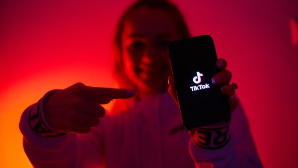 A girl in a dark environment promoting TikTok app on mobile (Shutterstock) TikTok plans to take Instagram down for good with new Photos app