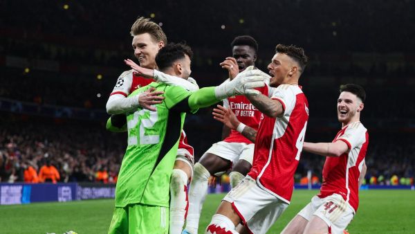 From L) Arsenal's Spanish goalkeeper #22 David Raya, Arsenal's Norwegian midfielder #08 Martin Odegaard, Arsenal's English midfielder #07 Bukayo Saka, Arsenal's English defender #04 Ben White and Arsenal's English midfielder #41 Declan Rice celebrate after winning the penalty shoot-out session of the UEFA Champions League last 16 second leg football match between Arsenal and Porto FC at the Arsenal Stadium in north London, on March 12, 2024. (Photo by Adrian DENNIS / AFP)