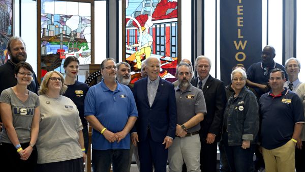 US President Joe Biden (C) poses with steel workers before speaking at the United Steelworkers Headquarters in Pittsburgh, Pennsylvania, on April 17, 2024. AFP Traffic Hike